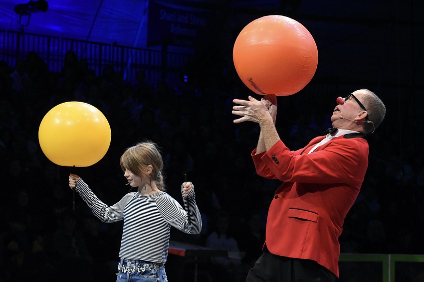 Elle Capel-Davies, a fifth grader at Bay Haven School of Basics Plus, is invited into the arena with Chris “Bucky” Allison to demonstrate concepts including torque, friction, angular momentum and centripetal force.