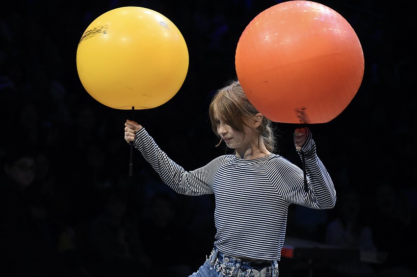 Elle Capel-Davies, a fifth grader at Bay Haven School of Basics Plus, is invited into the arena with Chris “Bucky” Allison to demonstrate concepts including torque, friction, angular momentum and centripetal force.