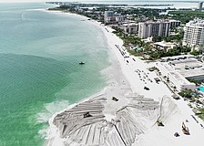 During a beach renourishment project, sand is placed and spread on the beach to extend the shoreline, combating natural erosion to increase recreational area space and extend the shoreline.