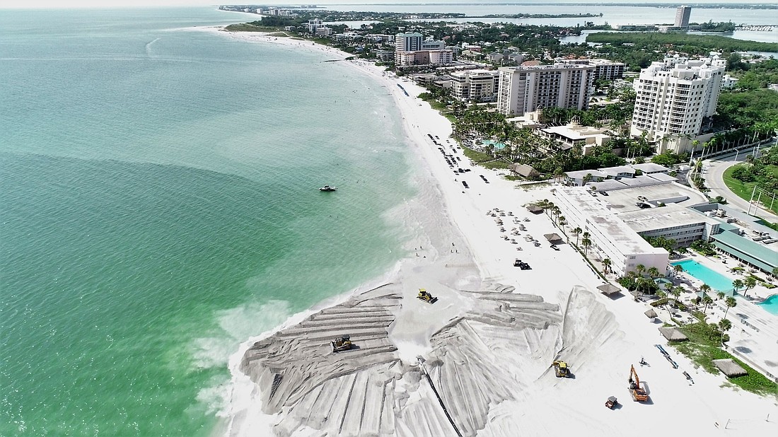 During a beach renourishment project, sand is placed and spread on the beach to extend the shoreline, combating natural erosion to increase recreational area space and extend the shoreline.