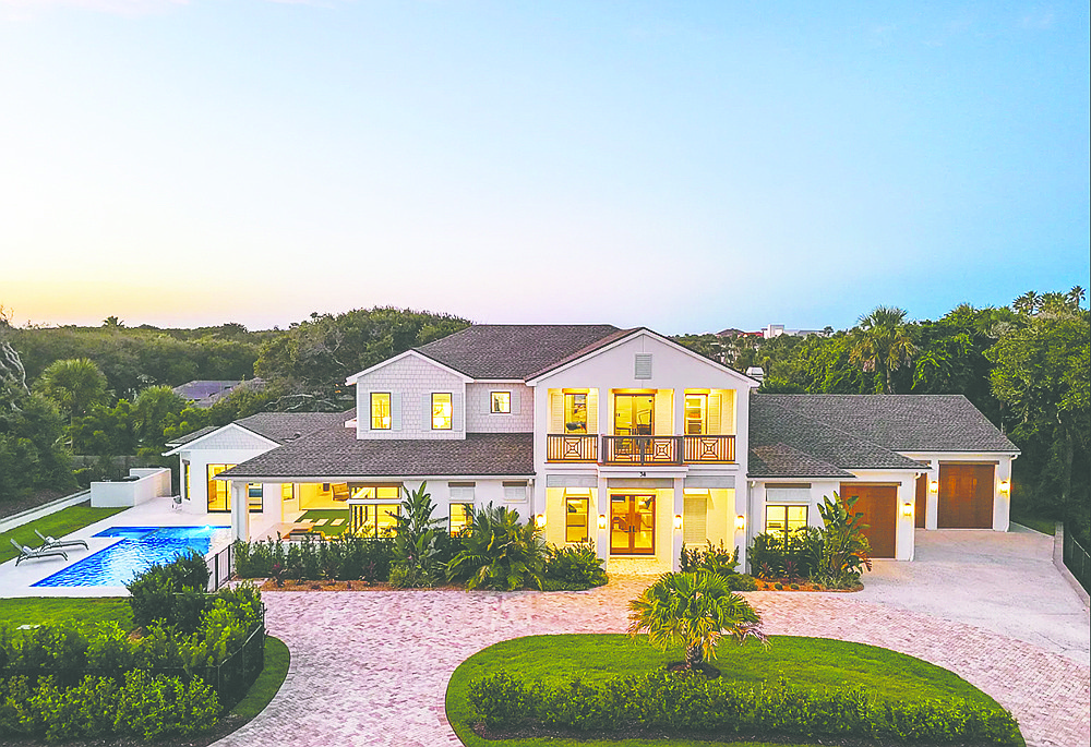 Ponte Vedra Beach two-story home features four bedrooms, four full and two half-bathrooms, office, guest suite, balcony, patio, porches and outdoor kitchen.