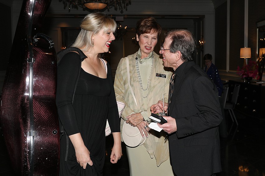 Principal cello player Natalie Helm shares laughter with board members Anne Folsom Smith and Peter Kretzmer.