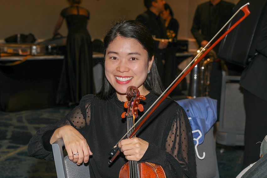Hannah Cho Dougherty warms up her violin for the gala performance.
