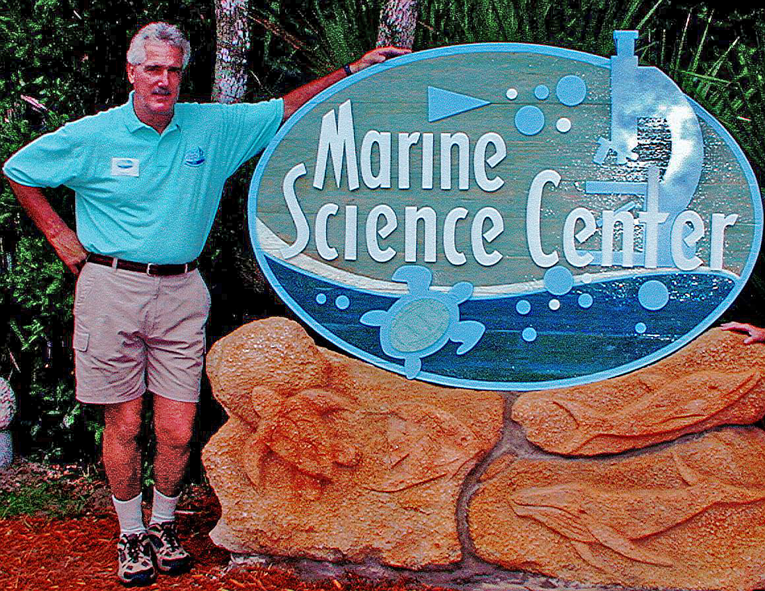 John Crisp stands next to the Marine Science Center sign when it first opened in 2002. Courtesy photo
