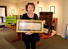 This year's New to You art sale promises some unique, larger finds for art enthusiasts, according to Linn Torres, All Angels by the Sea administrative assistant and art sale coordinator. Torres showcases a Grecian-style, three-dimensional piece of art.