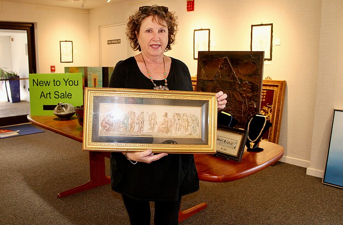 This year's New to You art sale promises some unique, larger finds for art enthusiasts, according to Linn Torres, All Angels by the Sea administrative assistant and art sale coordinator. Torres showcases a Grecian-style, three-dimensional piece of art.