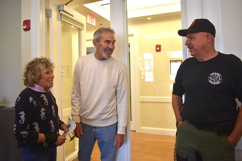 Lakewood Ranch's Patty Palmer and George Dolengowski visit with Kevin Vreeland, a K-9 handler with Manatee County Search & Rescue.