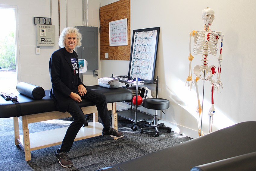 Chris Watts, lead therapist at the newly expanded Longboat Key Fitness, shows some of the new treatment tables at the studio.