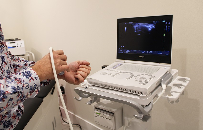 Dr. James Reed demonstrates the new equipment at Reed Medical Group's expanded Bay Isles location.