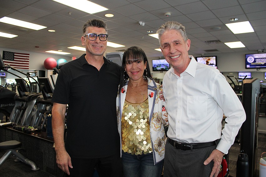 Secur-All Insurance owner Sandra Smith and Lazy Lobster owner Michael Garey congratulate Longboat Key Fitness owner Petar Sibinkic on the opening of his expanded personal training studio.