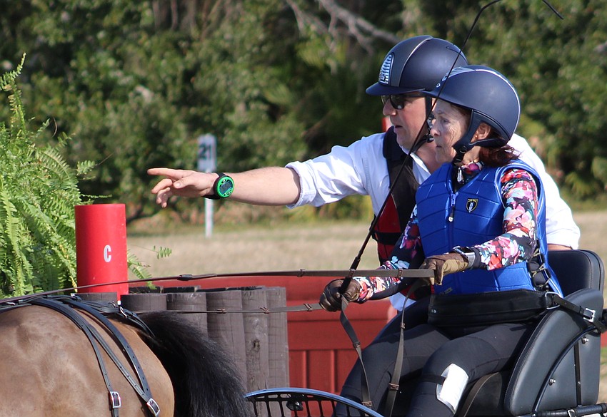 Driver Michelle Du Bois gets a little directional help from her navigator during the Combined Driving at TerraNova competition Jan. 24 in Myakka.