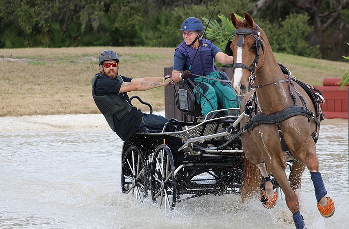 Navigator Gary Yeager balances the cart as driver Kami Landy goes into a turn during the Combined Driving at TerraNova marathon event Jan. 24.