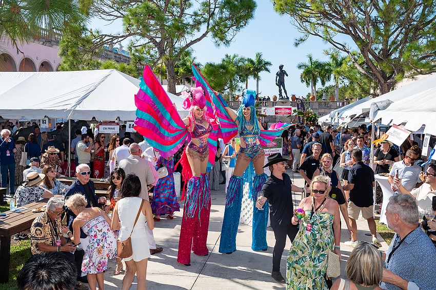 The Parrothead Stilt Walkers entertain the crowd.