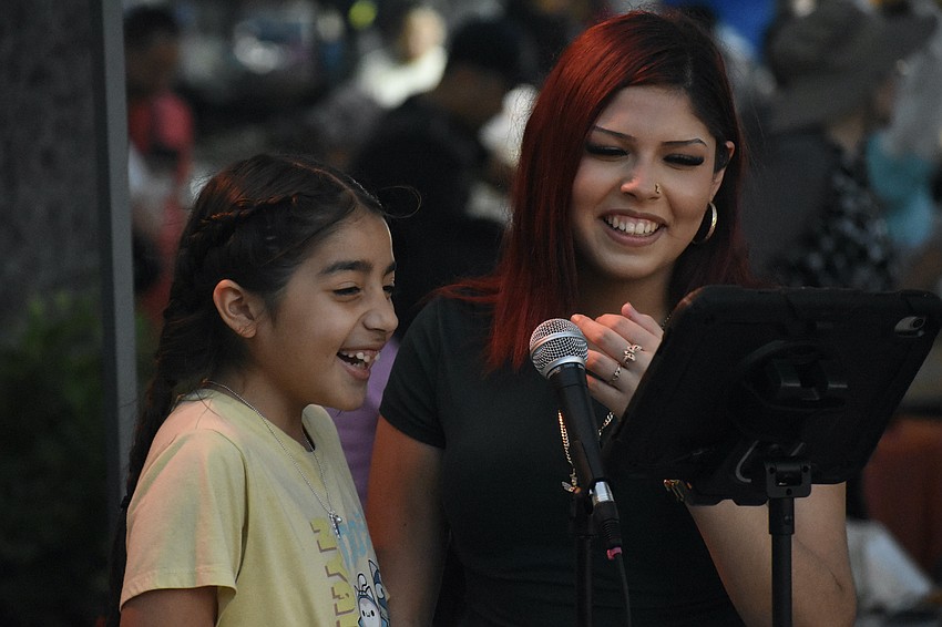 Cataleya Alvarez, 8, and Leaylah Zuniga sing a round of karaoke.