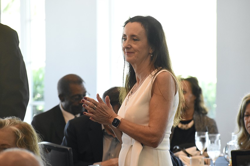 Secretary Domini Wood (Lt. Commander) applauds during the ceremony.