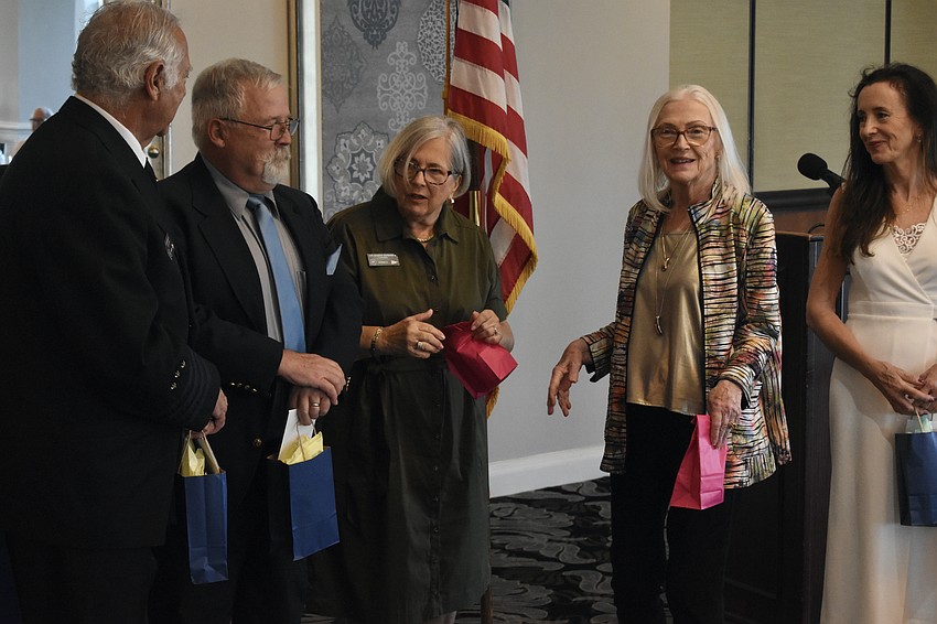 Immediate Past Commander Barbara Warshaw (center) hands out gifts to the new bridge including Commander David Siesel; Executive Officer Samuel Doak (Lt. Commander), Administrative Officer Lois McKenzie (1st Lt.) and Secretary Domini Wood (Lt. Commander).