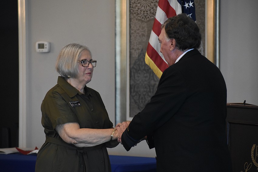 Immediate Past Commander Barbara Warshaw is relieved of her duties by District Comander Ron Jones.