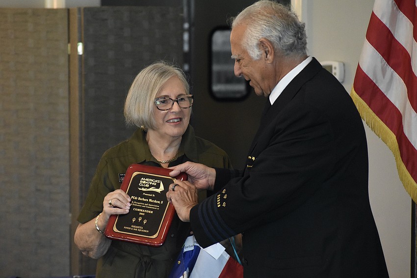 Immediate Past Commander Barbara Warshaw is honored with a plaque from Commander David Siesel.