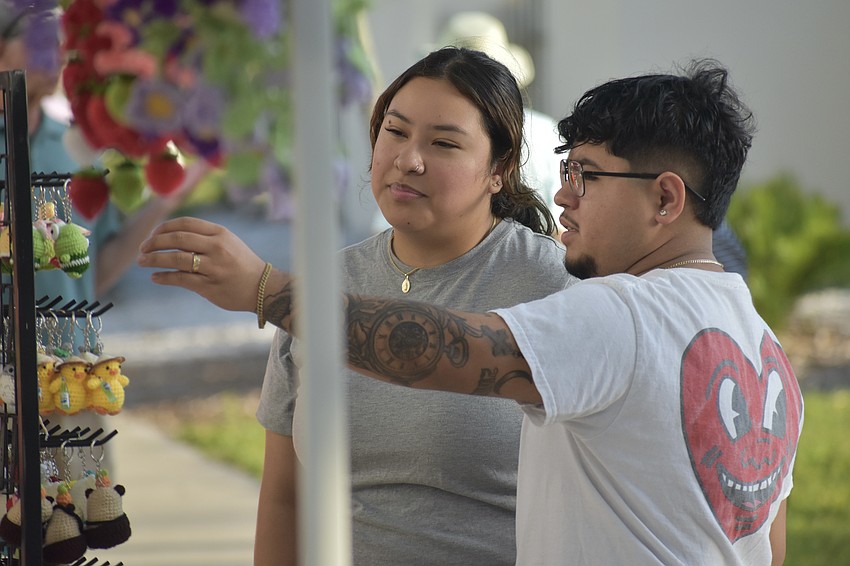 Aline Romero and her husband, Chris Romero, browse crochet items.