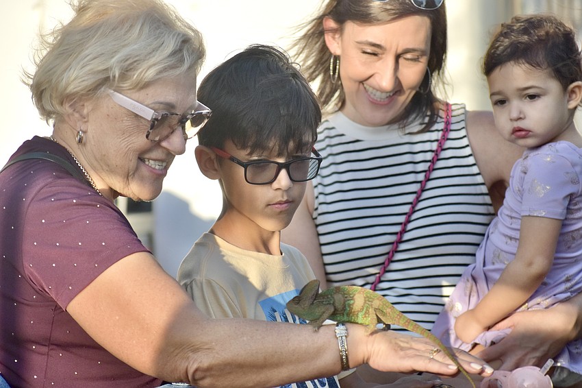 Julian Aggarwal, 8 (center) meets Chamillionaire his grandmother Halina Kondratowicz, mother Izabela Aggarwal and Olivia Aggarwal, 2, at the Emit's Adventure tent.