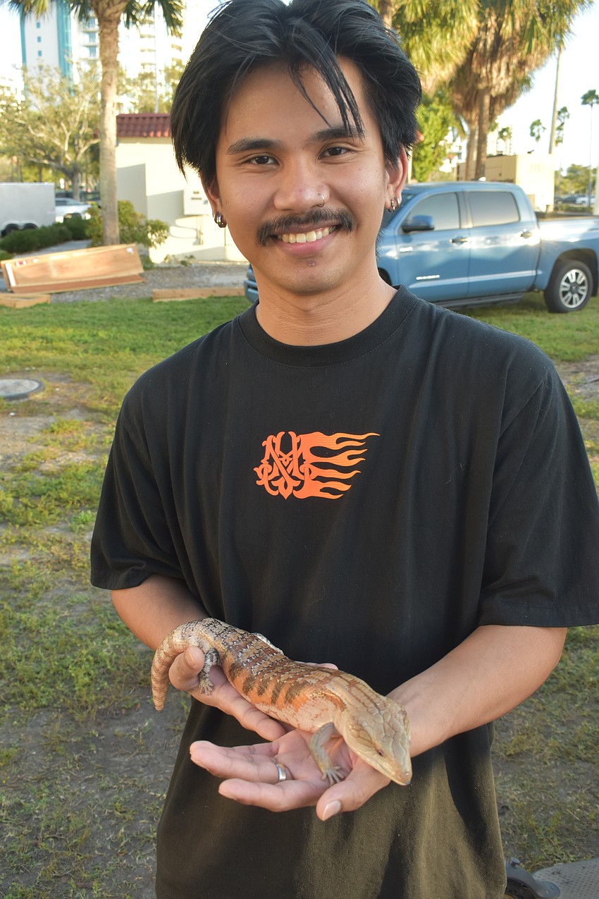 Andrew Mendoza holds Baby Boy, a blue-tongued skink who was showcased at Emit's Adventure.