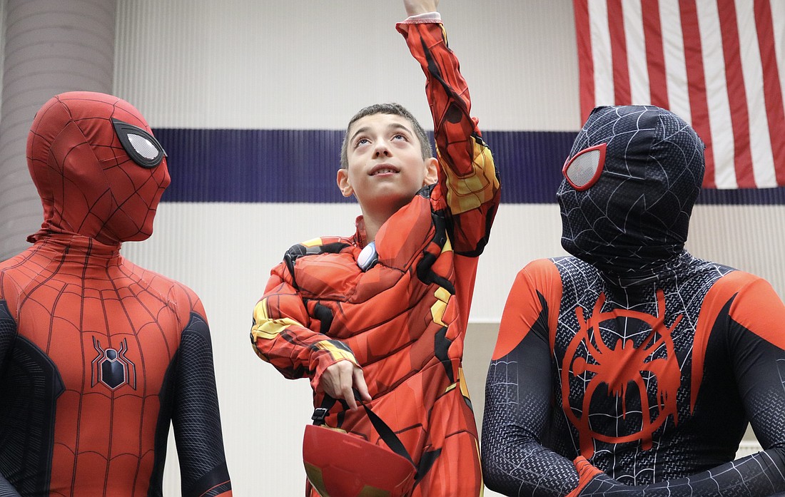 Myles Murillo dressed up as Iron Man and played with two Spider-Mans.
