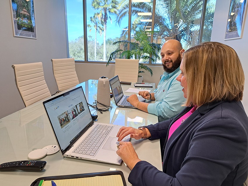 Amanda Lasecki, vice president of Operations at CF/UWVFC, and Emmanuel Kamel, Foundation Support Specialist at CF/UWVFC, access information via the organization’s new website. Courtesy photo