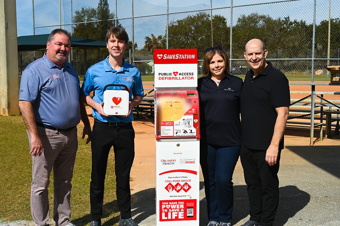 Joe and Matt Cobb celebrated the installation of an AED at Veterans Memorial Park with Andy and Martha Anderson.