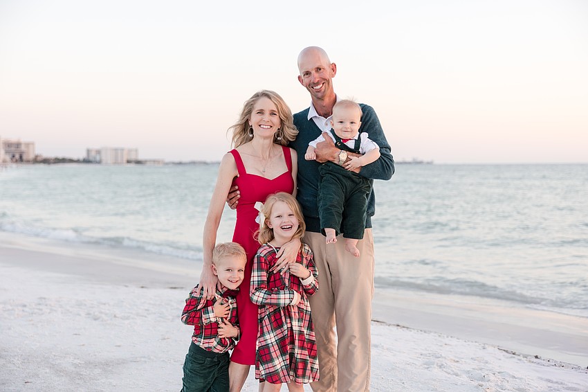 Chelsea and Stephen Arnold enjoy a day at the beach with their 5-year-old, 3-year-old and 10-month-old children.