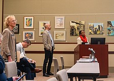 Christ Church pastor Julia Piermont (standing, left) attended a Lonbgoat Key Planning Board quasi-judicial hearing where the board approved the redevelopment of a neighboring lot into 58 parking spaces.