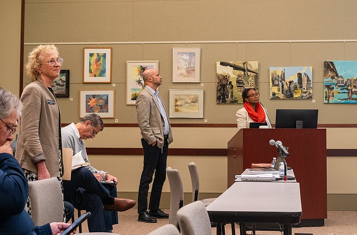 Christ Church pastor Julia Piermont (standing, left) attended a Lonbgoat Key Planning Board quasi-judicial hearing where the board approved the redevelopment of a neighboring lot into 58 parking spaces.