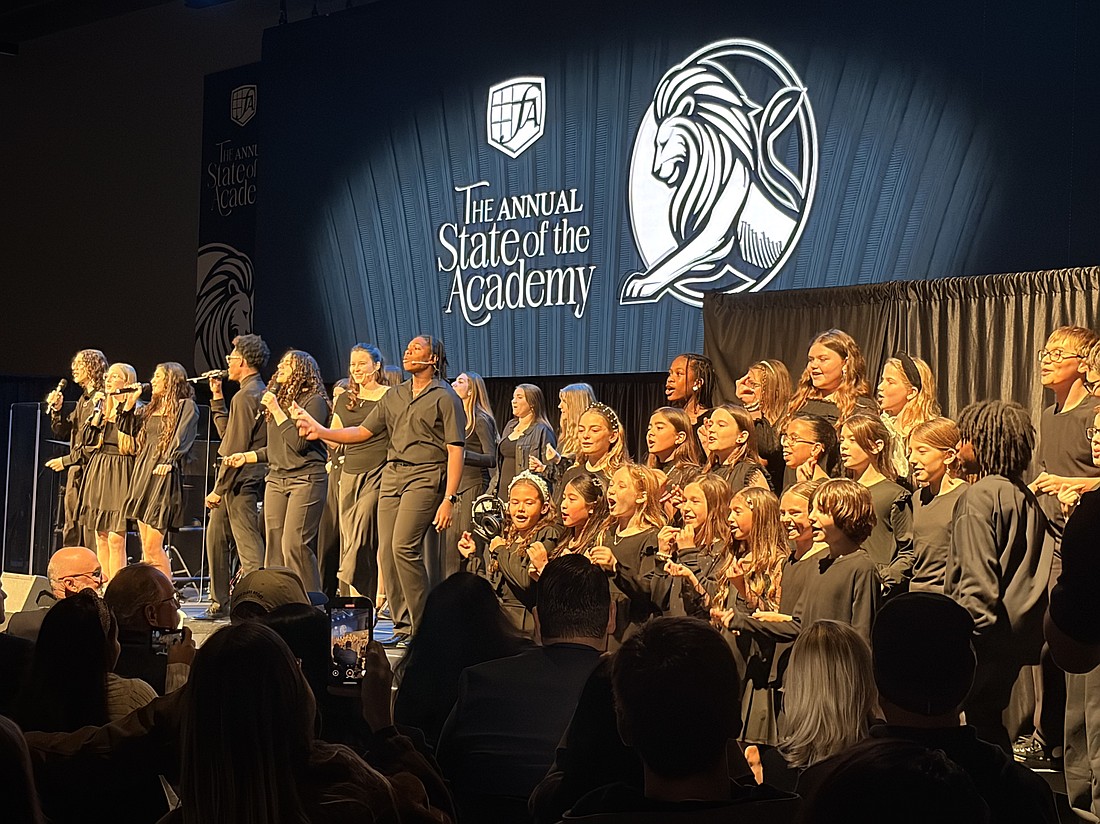 Students sang worship songs on stage while the crowd cheered and sang along.