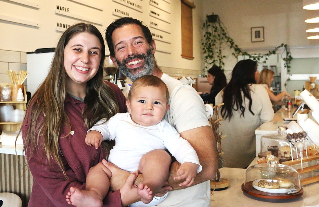 The McDermott family in Flagler Beach is expanding their Yes Coffee shop into The Hammock with a drive-thru only location. Pictured: Mike and Rachel McDermott with 7-month-old Milo. Photo by Sierra Williams
