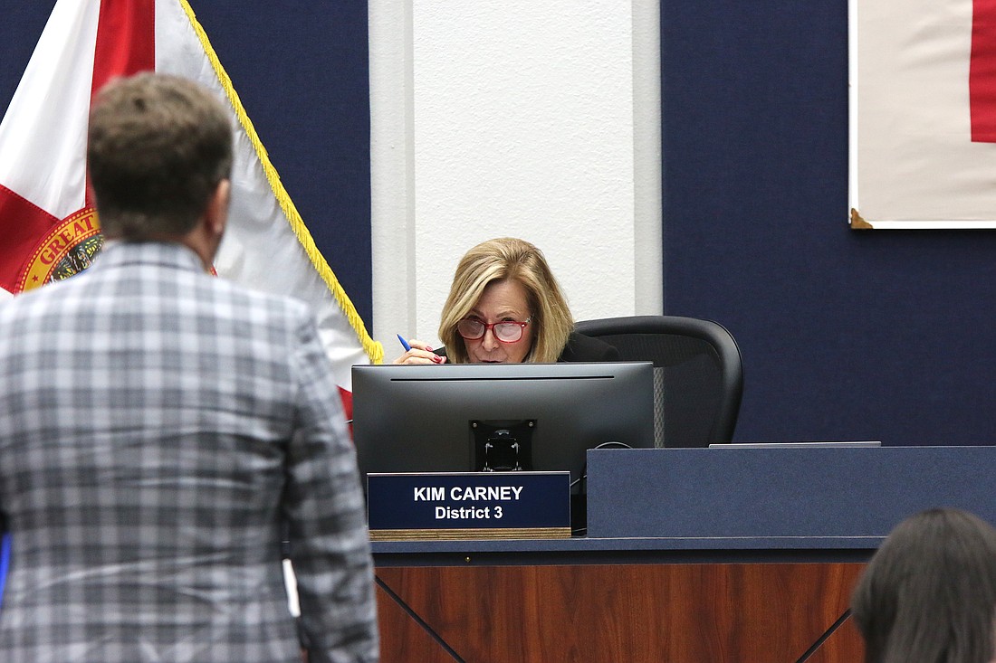 Flagler County Commissioner Kim Carney questions Flagler Beach Attorney Drew Smith. Photo by Sierra Williams