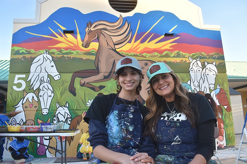 Lillian Fox and her mother Stephanie Guevara, who works at the school as the art teacher, painted 75% of the mural before letting students help during the CommUNITY Night.