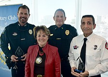 Officer Michael Skinner (representing honoree Ron Dixon) of the Sarasota Police Department; Rotary Club president Pam Akins; Lieutenant Bruce King of the Sarasota Police Department; and honoree Gabe Gadah of Sarasota County Fire Department gather together.