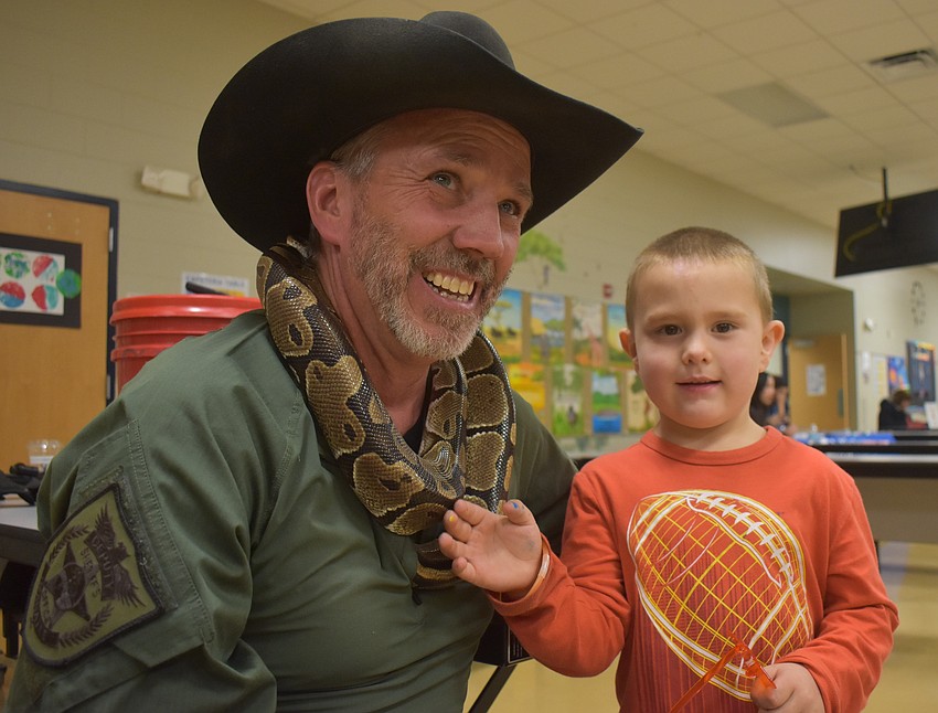 Sergeant Rob Hendrickson with the Manatee County Sheriff's Office brought a ball python for the kids to see and touch. Maddox Bradow, a voluntary prekindergarten student, was especially interested in the snake and asked lots of questions.
