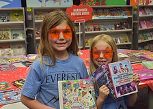 Myakka City Elementary first graders Delanee Verly and Emma Kelly check out the wide variety of books for sale during the CommUNITY Night.