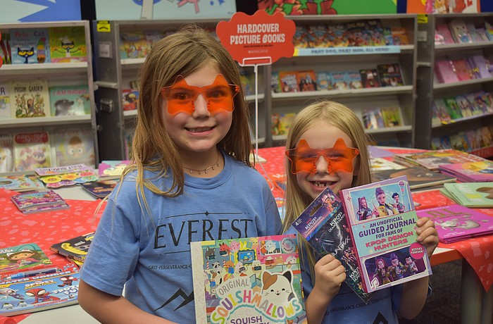 Myakka City Elementary first graders Delanee Verly and Emma Kelly check out the wide variety of books for sale during the CommUNITY Night.