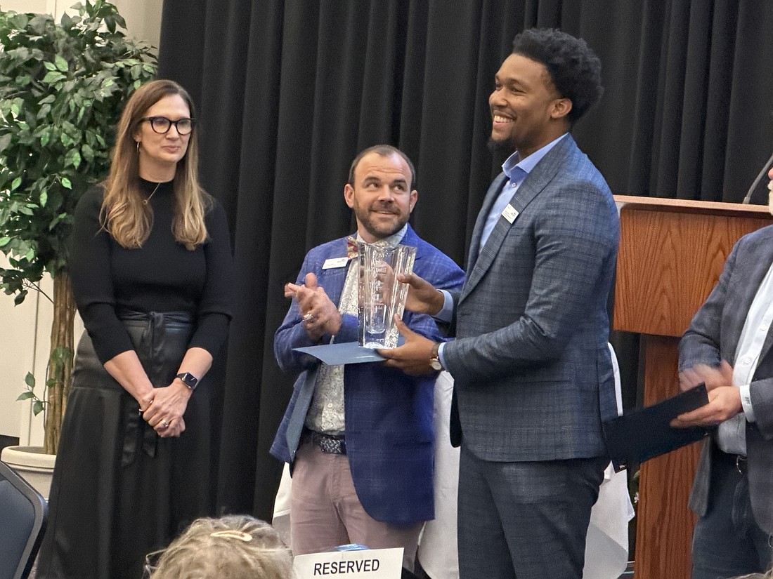 Darrin Eakins shows off his trophy after being named 2026 Overall Small Business Leader of the Year on Jan. 29.
