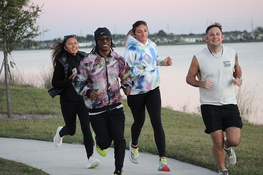 Run the Ranch members Pamela Kurpiewski, co-founder Alex Wordsworth, Sage Lyons and Benjamin Noto run at Waterside Place on Jan. 27.