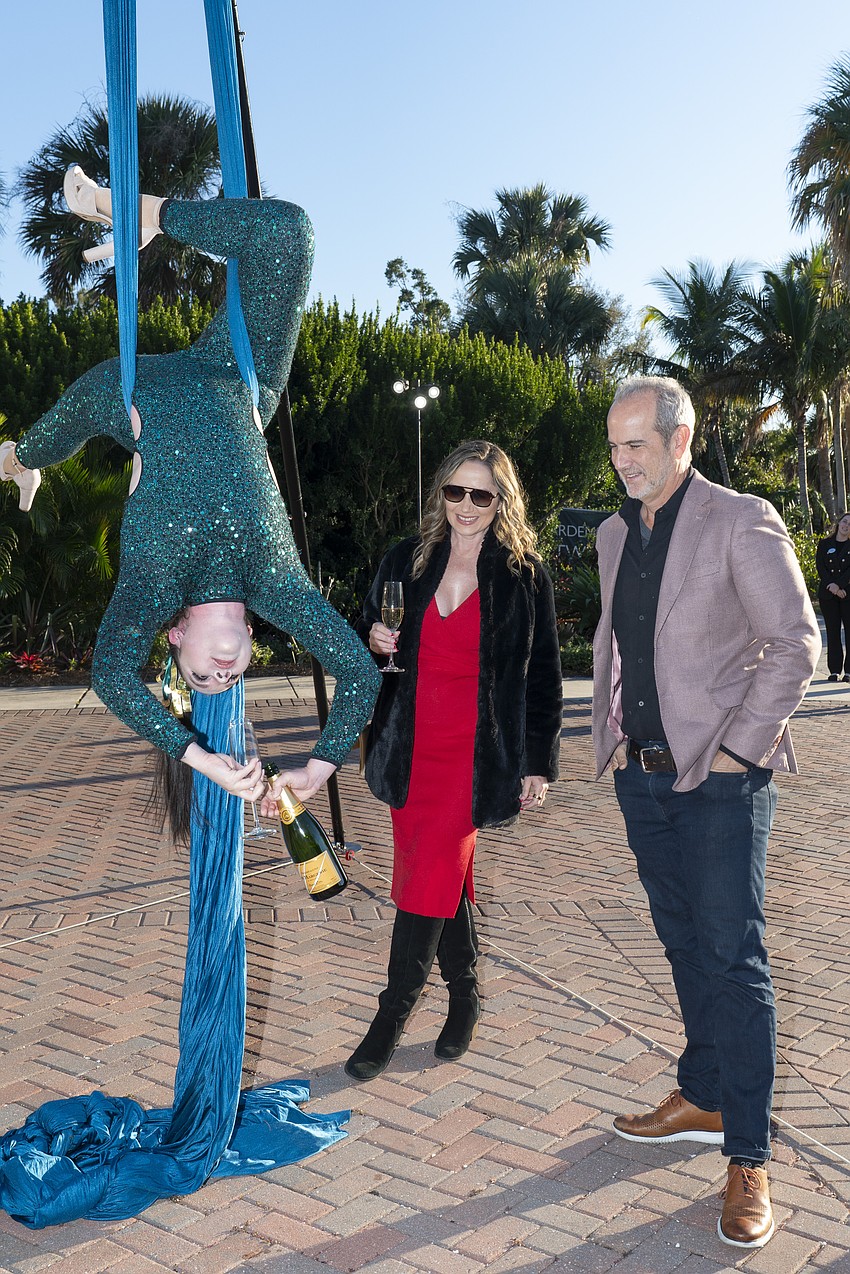 Guests were treated to champagne poured by an upside down aerialist at the sales kickoff for the Waldorf Astoria Residences Sarasota.