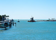 The dredging machine “Clearwater” digs a 13 foot, 180-foot-wide ditch on the bottom of New Pass, using pumps to carry the dredged sediment through miles-long pipes onto the northern end of Lido Key for a renourishment project.