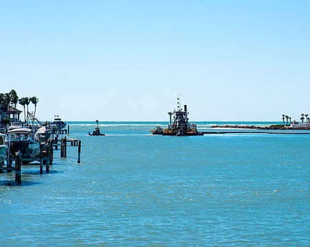 The dredging machine “Clearwater” digs a 13 foot, 180-foot-wide ditch on the bottom of New Pass, using pumps to carry the dredged sediment through miles-long pipes onto the northern end of Lido Key for a renourishment project.