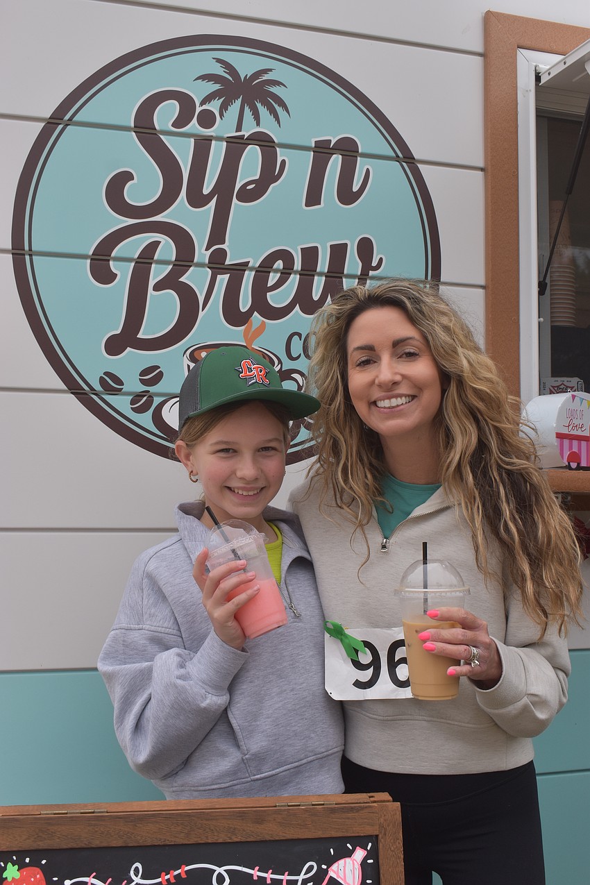 Mackenzie Shinn and Janel Shinn enjoy refreshments from the Sip n Brew coffee trailer after the race. Janel says that although her children graduated from All God's Children Preschool, she was eager to return to support the Miles family.