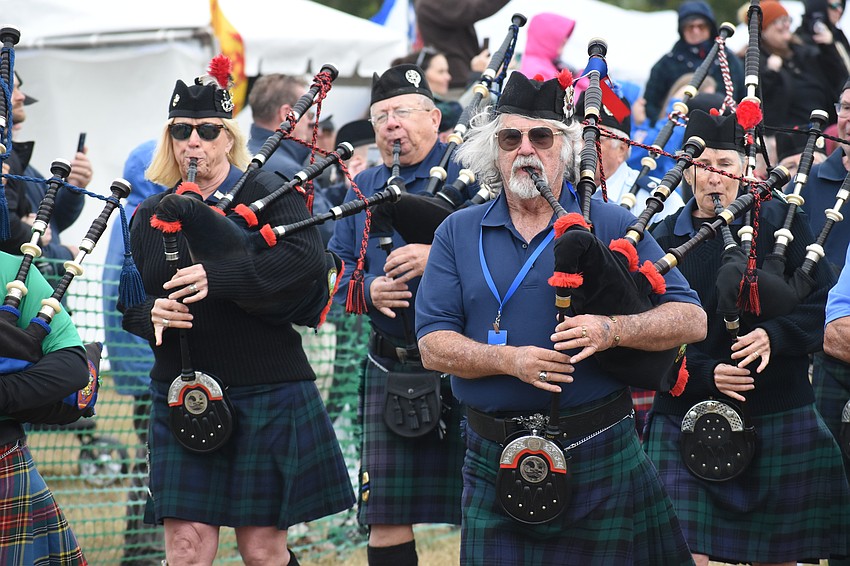 Leslie Jones and Bob Fair, president of Suncoast Scots, march in the opening ceremony.