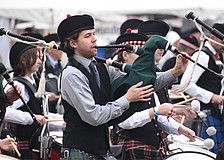 Ethan Kuhn of Suncoast United Pipes and Drums performs in the ceremony.