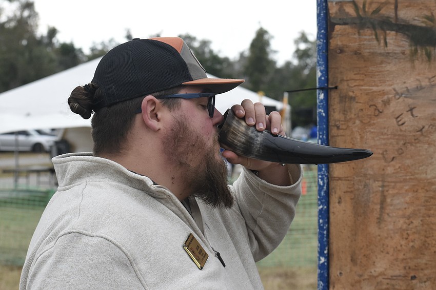 Jason Briggs, Georgia state commissioner of the Clan Irwin Association, takes a swig from a drinking horn.