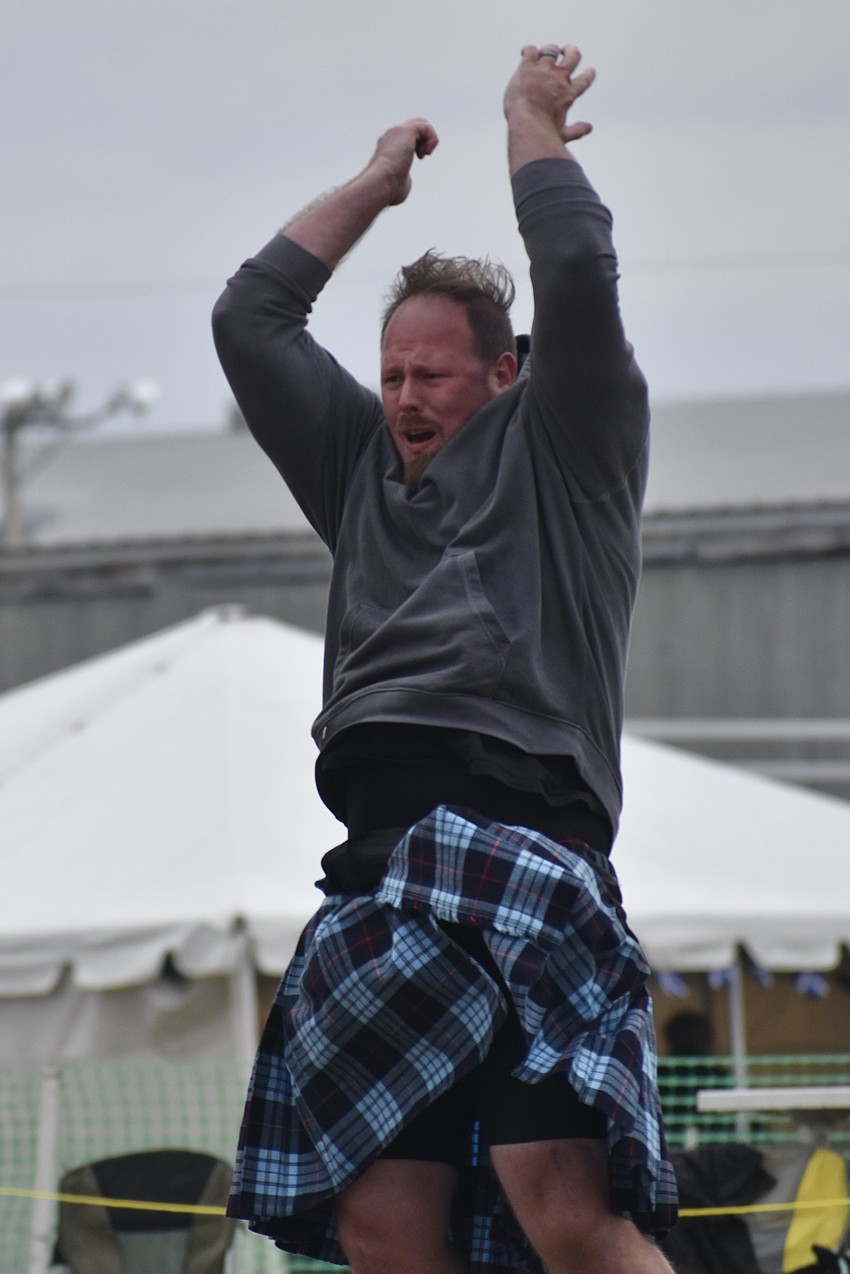 Cameron Gadway of Palm Harbor tosses a caber.