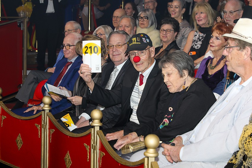 Dr. Bart Levenson and his wife, Joan, raise a paddle in support of the CAC.